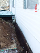 Allstate Animal Control skunk barrier being installed around a crawlspace